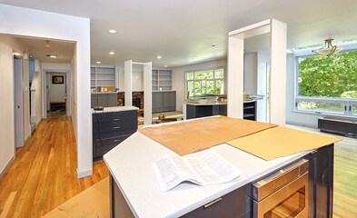 Kitchen temporarily housing shelf frames for another room as cabinet and shelving installation...