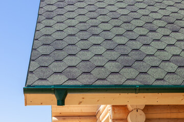 the roof of the house is covered with soft tiles, bitumen shingles