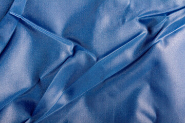 Texture backdrop photo of blue colored and folded bologna fabric. - obrazy, fototapety, plakaty