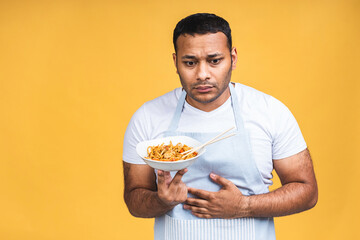 Portrait of of unhappy african american indian black man chef cooking pasta and having stomach...