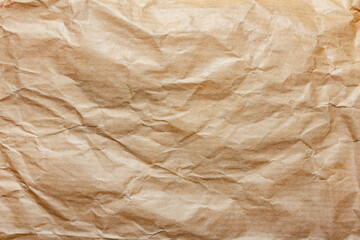 Fototapeta premium Texture backdrop photo of brown colored crumbled packing paper surface.