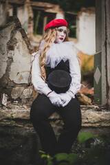 The girl with makeup of the mime. improvisation. Suit for Halloween. mime shows different emotions. Sad clown