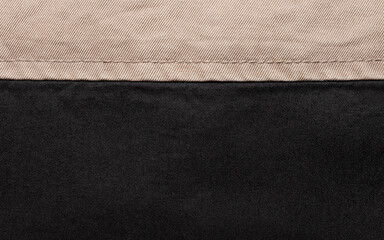 Texture backdrop photo of beige and black colored denim cloth.