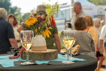 white wine glasses on table with flowers