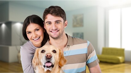 Love And Care Concept. Portrait of cheerful couple patting their dog