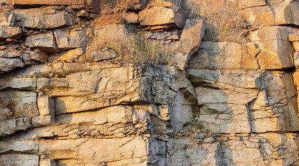 Texture backdrop photo of stone or rock wall on sunset lighting.