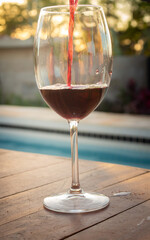 Crystal goblet with red wine. Alcoholic drink based on fermented grape juice. High social class drink concept.