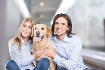 Love And Care Concept. Portrait of cheerful couple patting their dog