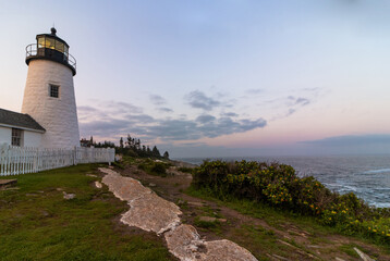 Fototapeta na wymiar Pemaquid Point Lighthouse in Bristol, Maine, at sunset on a summer evening