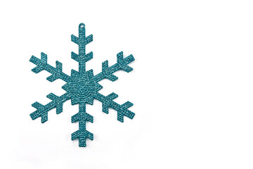 Cyan colored snowflake, Christmas ornament on white background with space for text, minimal concept