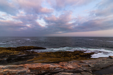 Coastal Maine rocky coast view from Pemaquid Point Lighthouse in Bristol, Maine, at sunset on a summer evening