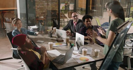 Team of diverse creative developers doing a highfive while discussing marketing customer orientation strategy - business success 4k footage