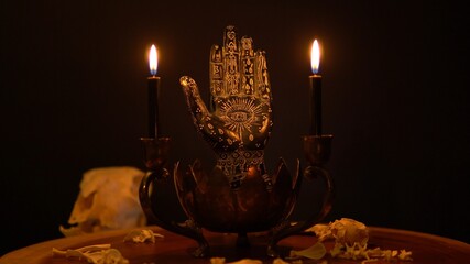Fortune teller hand or palmistry on the witch table with animal bones. Palmistry with black palm...
