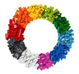 top view of pile of many various colorful rainbow colored stackable plastic toy bricks in circle...