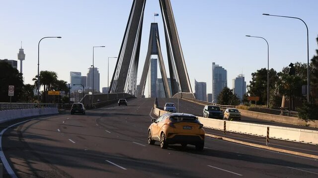 Wide multi-lane highway through Anzac bridge to Sydney city CBD in 4k.
