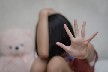 Kid girl showing hand signaling to stop useful to campaign against violence and pain. Stop abusing....