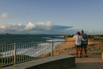 People enjoying the sunrise view from Lambert's Beach lookout, Mackay Queensland Australia - obrazy, fototapety, plakaty