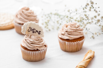 Tasty wedding cupcakes on table