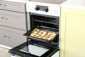 Electric oven with potato in kitchen