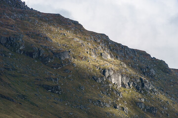 Detail of rocky hill touched by golden sunlight in beautiful landscape, Scotland