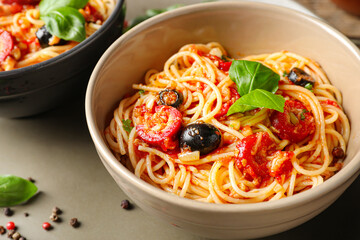 Bowls with tasty Pasta Puttanesca on table, closeup