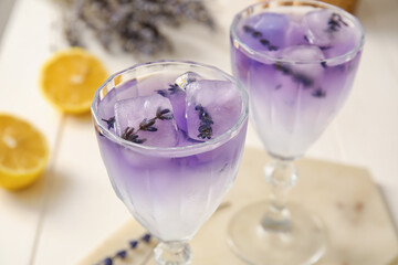Glasses of fresh cocktail with lavender on table, closeup