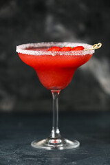 Glass of tasty strawberry margarita on dark background, closeup