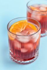 Fototapeta na wymiar Glasses of tasty Negroni cocktail on color background