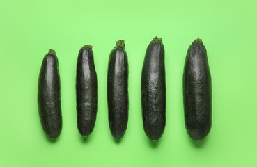 Fresh zucchini squashes on color background
