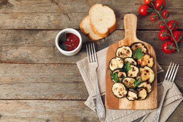 Composition with tasty grilled zucchini on wooden background