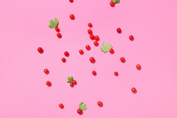 Fresh red currants and leaves on color background