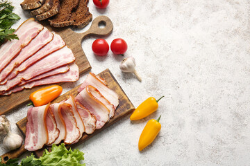Composition with slices of tasty smoked bacon on light background