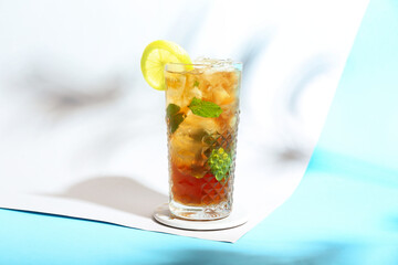 Glass of tasty Long Island iced tea on color background