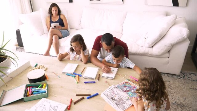 Family coloring and drawing in living room