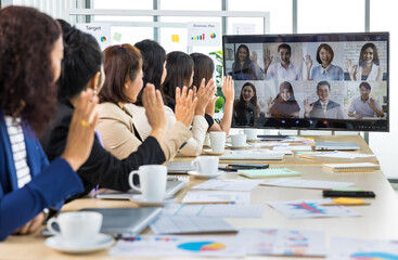 Six asian business women sitting on the table wave greeting on online conference call meeting through screen in office. Concept for online meeting