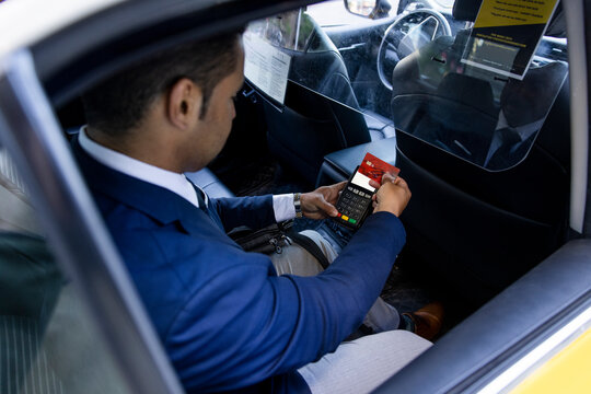 Businessman paying for taxi with smart card