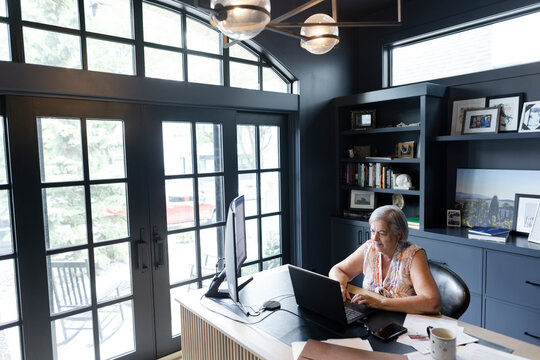 Senior woman working from home at laptop in home office