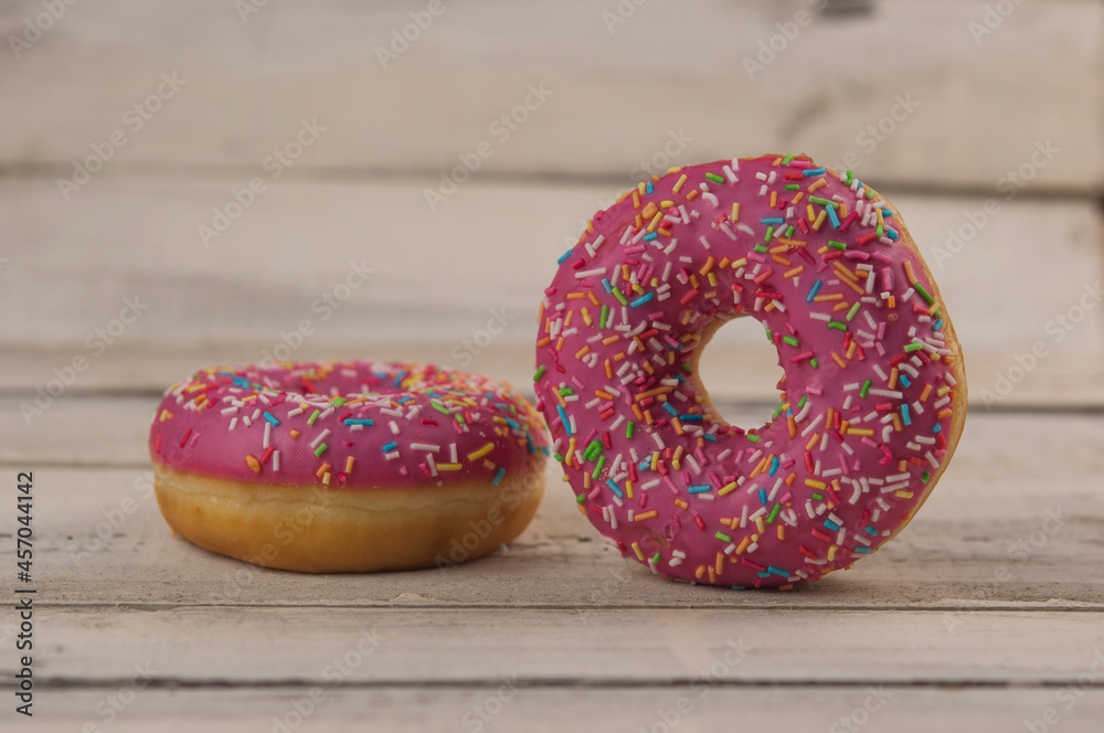 Poster raspberry donuts on a wooden table