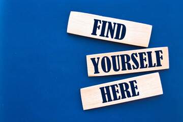 Find Yourself Here Text on Wooden Blocks on blue Background