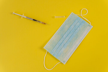 Flat Lay for medical theme and vaccinations from COVID-19. Medicine, vaccine, syringe, mask.