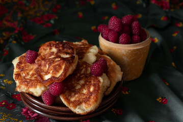Homemade puffy ruddy pancakes with raspberries.