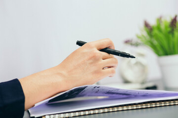 The hands of a businesswoman sweating so much that the paper jammed in her palm. 