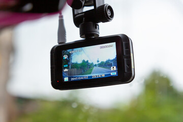 Car recorder cam mounted on the front windshield recording the traffic ahead in case of an emergency situation.