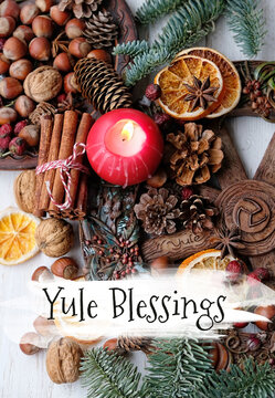 Yule Blessings. Winter altar for Yule sabbath. pagan holiday. candle, wheel of the year, cinnamon, nuts, cones on table. Esoteric Ritual for Yuletide, Magical Winter Solstice. top view