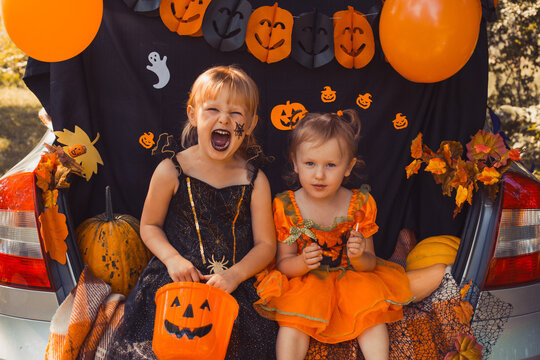 Children Celebrating Halloween In Trunk Of Car.