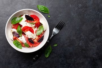 Caprese salad with fresh tomatoes, basil and mozzarella cheese