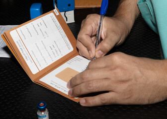 A veterinarian signing vaaccination records