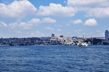 Fototapeta premium Panoramic view of Istanbul. Strait of Bosphorus, ship and coastline with houses. 09 July 2021, Istanbul, Turkey.