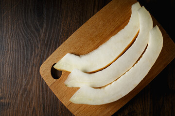Melon, honey melon on wooden table background.