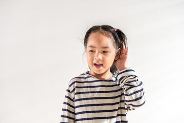 Happy Positive cute Asian little toddler kid girl holding ear with hand listening to a hearing for...
